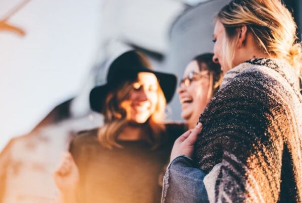 A group of coworkers looks happy and content during a break or team-building activity, sharing lighthearted moments together.