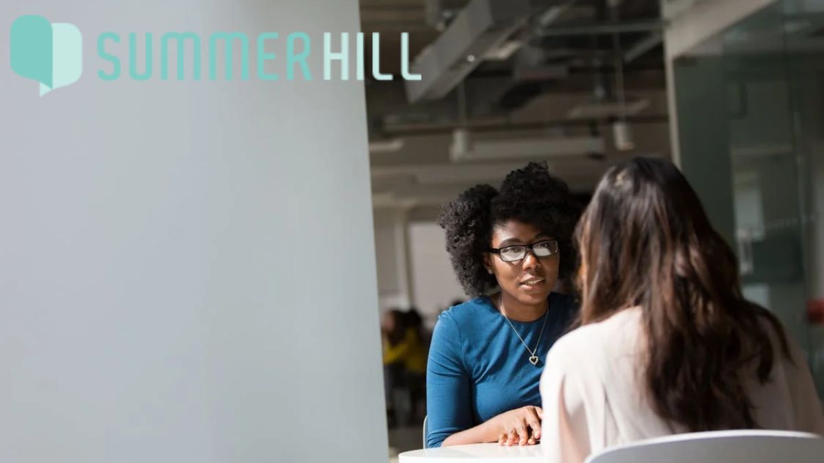 Female patient speaking with a therapist, receiving career advice on achieving work-life balance.