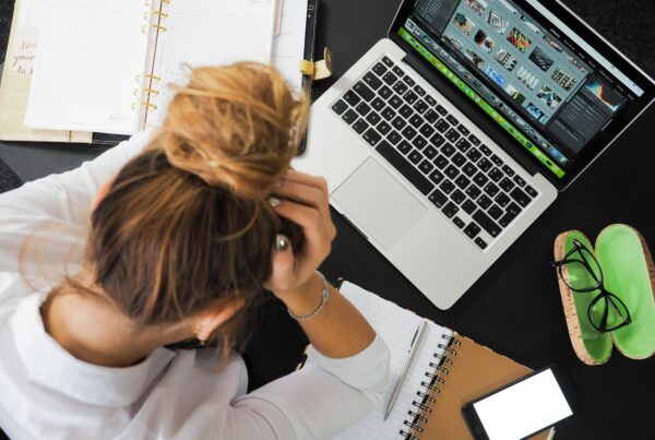 A woman juggling multiple deadlines on her computer, trying to stay on top of her work.