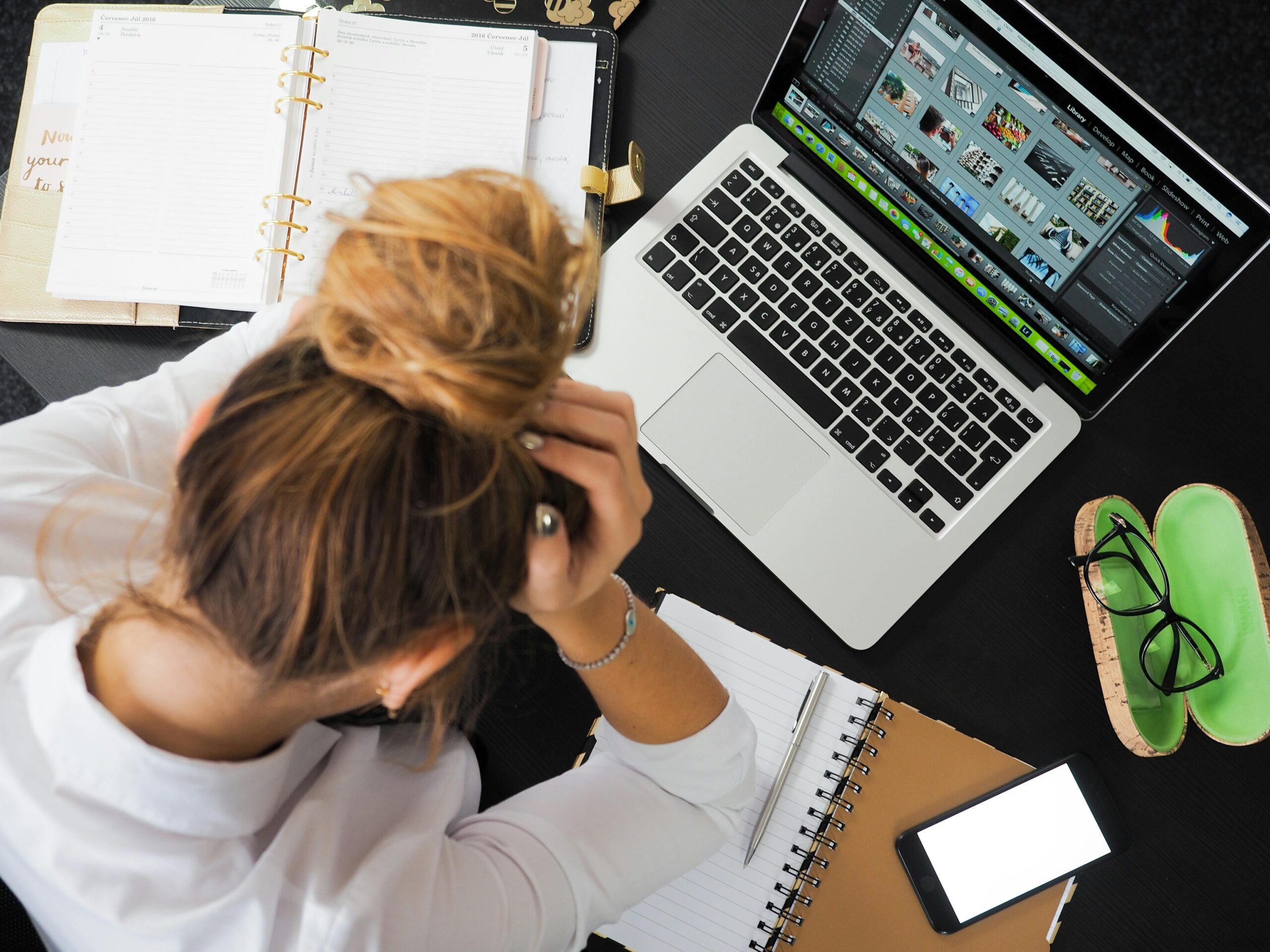 A woman juggling multiple deadlines on her computer, trying to stay on top of her work.