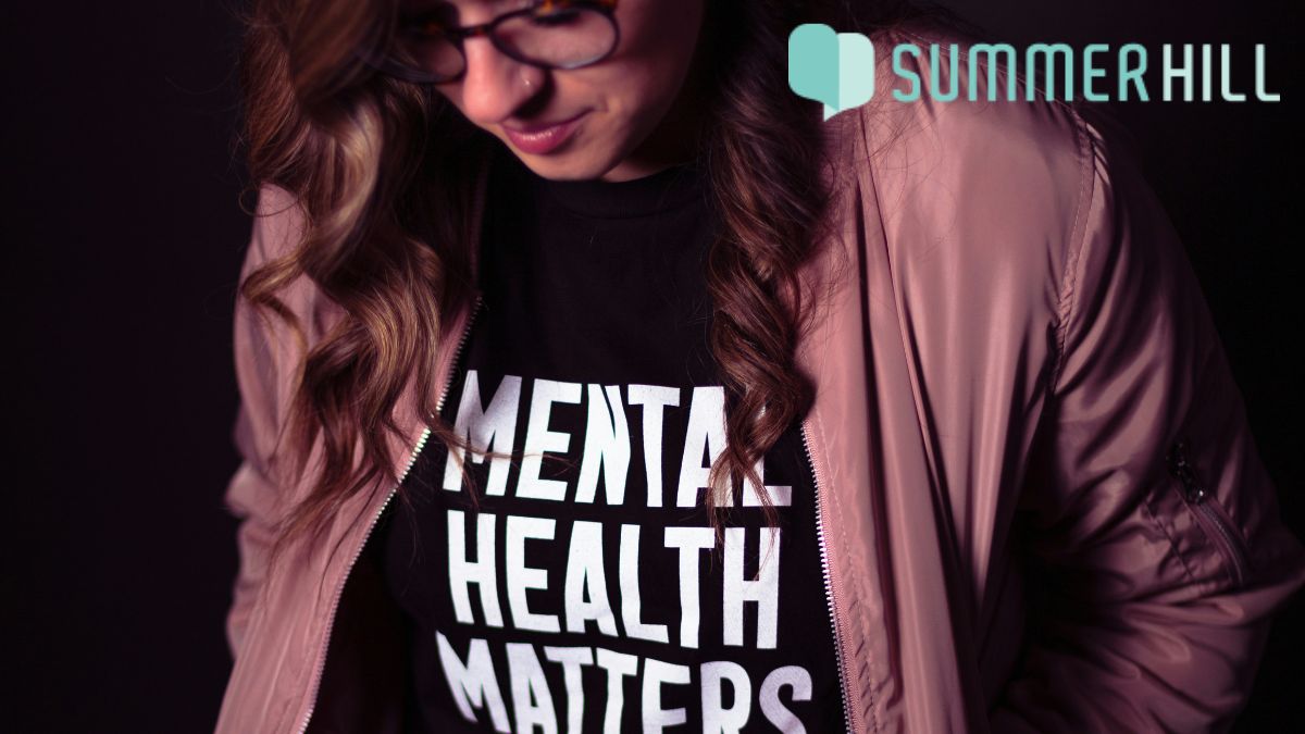 Mental health clinic services, a woman wearing a T-shirt promoting mental health awareness advocacy.