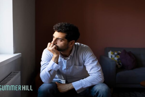 Sad and lonely guy watching outside the window