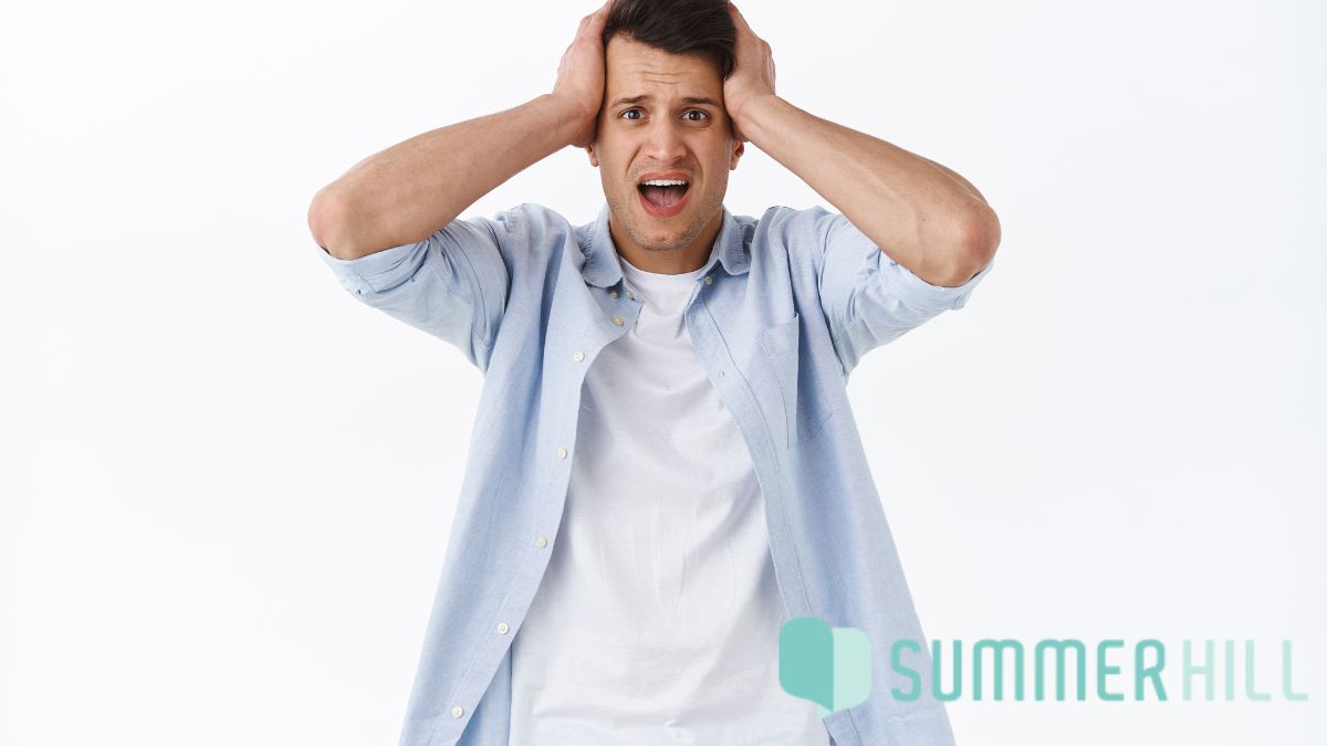 Outgrown your current therapist: a man wearing casual clothes shows a look of shock and frustration against a white wall backdrop.