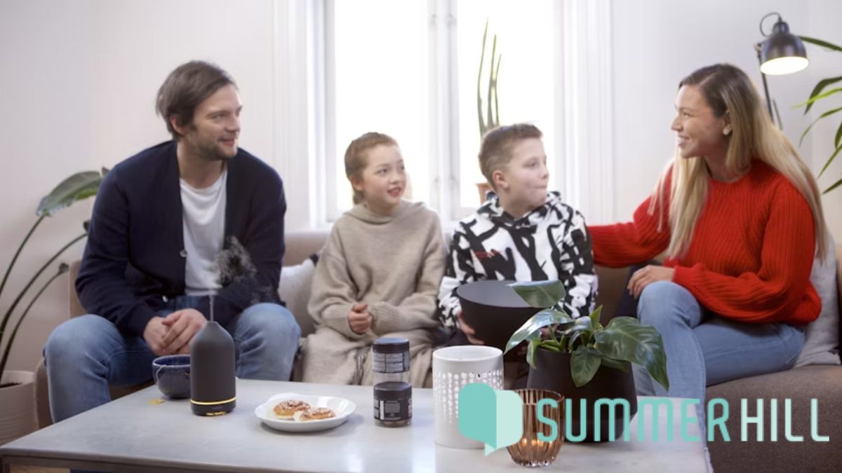 A family group with children participates in a counseling session, engaging in a lively discussion and sharing a warm bonding moment as the therapist guides the conversation.