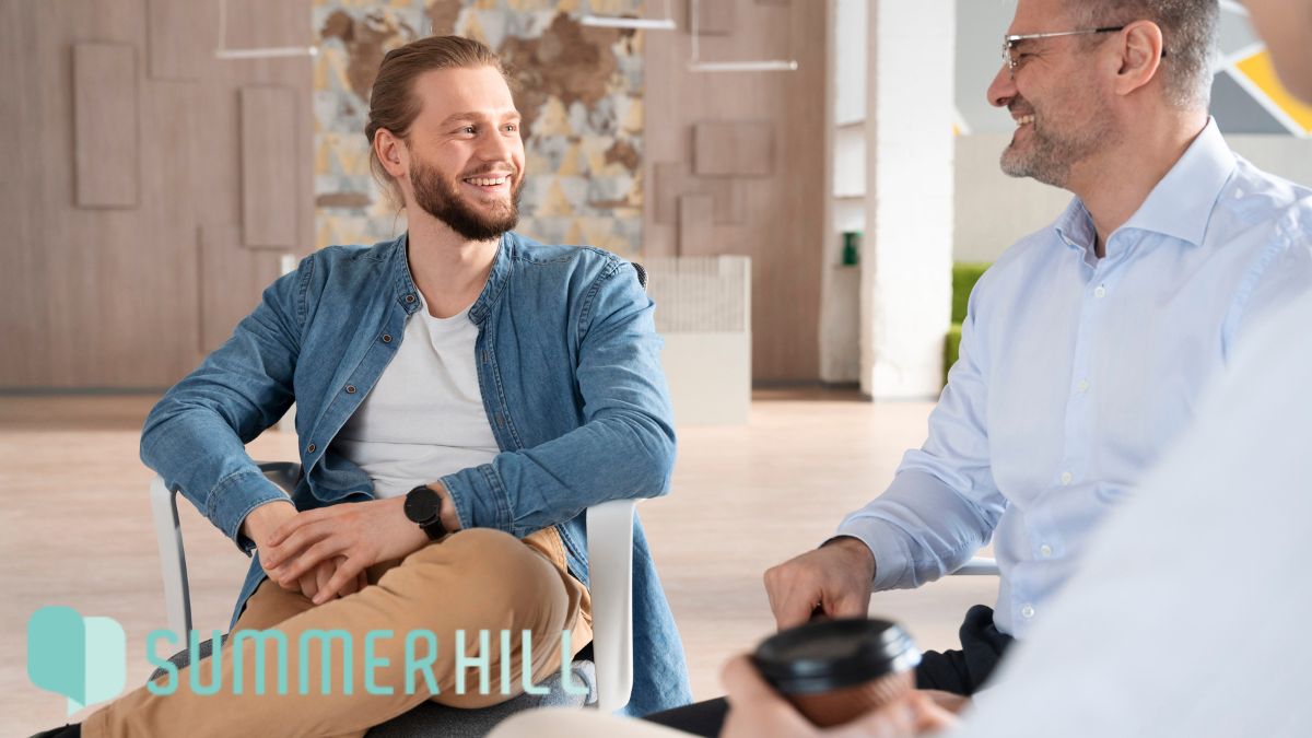 Male adults engage in guided discussions about self-care during therapy session together.