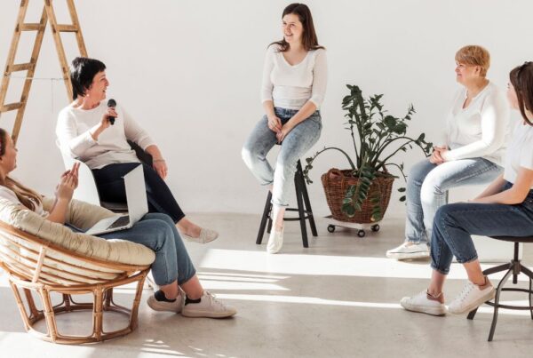 Women engage in a calming indoor therapy session focused on self-care practices.
