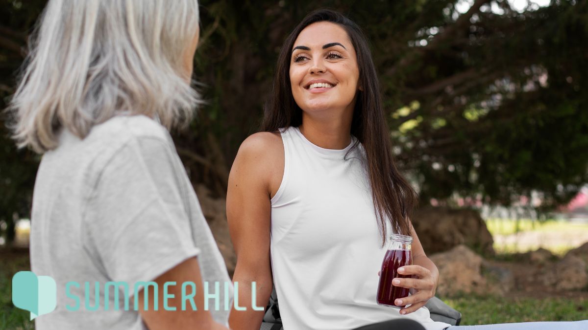 A woman and therapist engage in self-care therapy with outdoor physical activities.